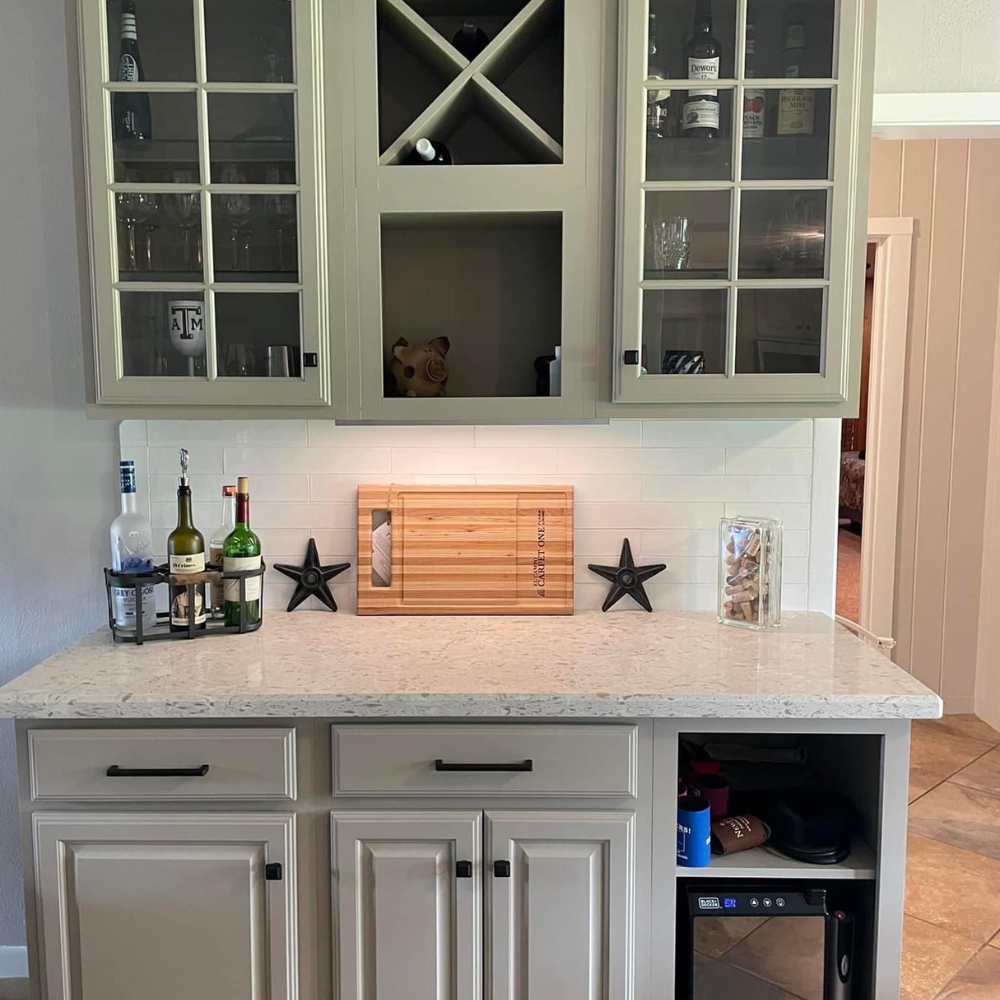 Glass front green kitchen cupboards. 
